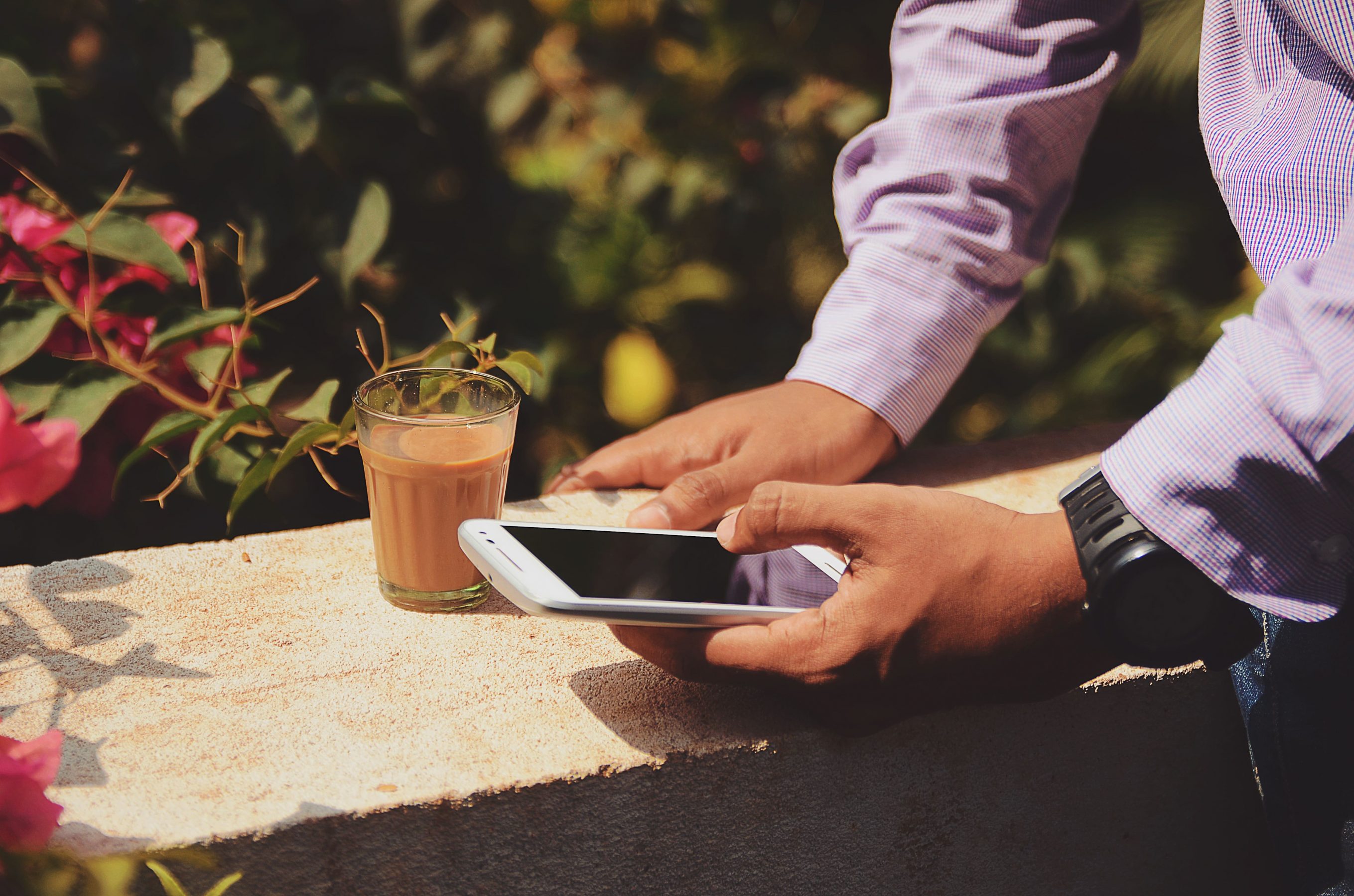 Man, smartphone and flower