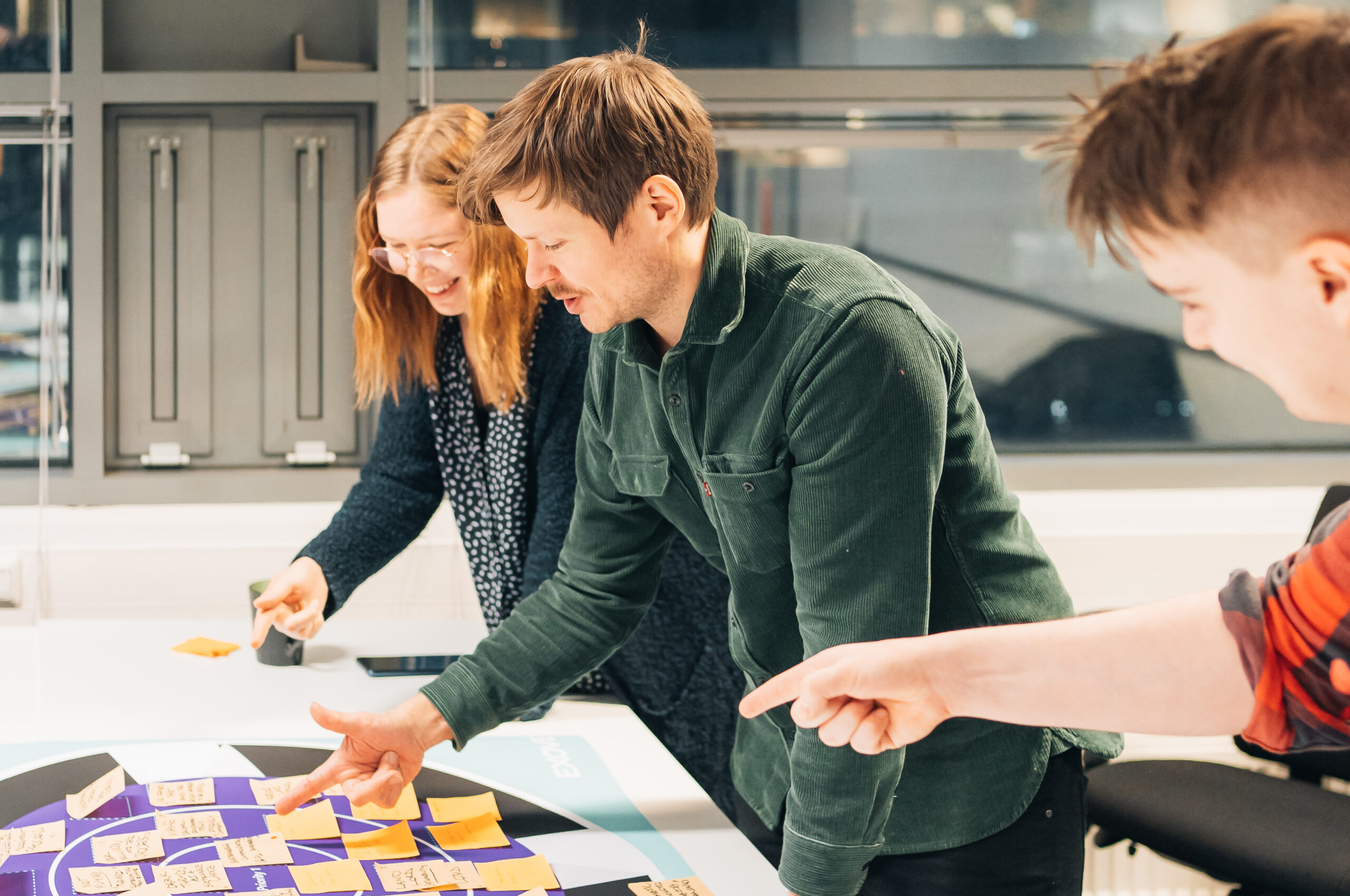 Three people having a workshop.